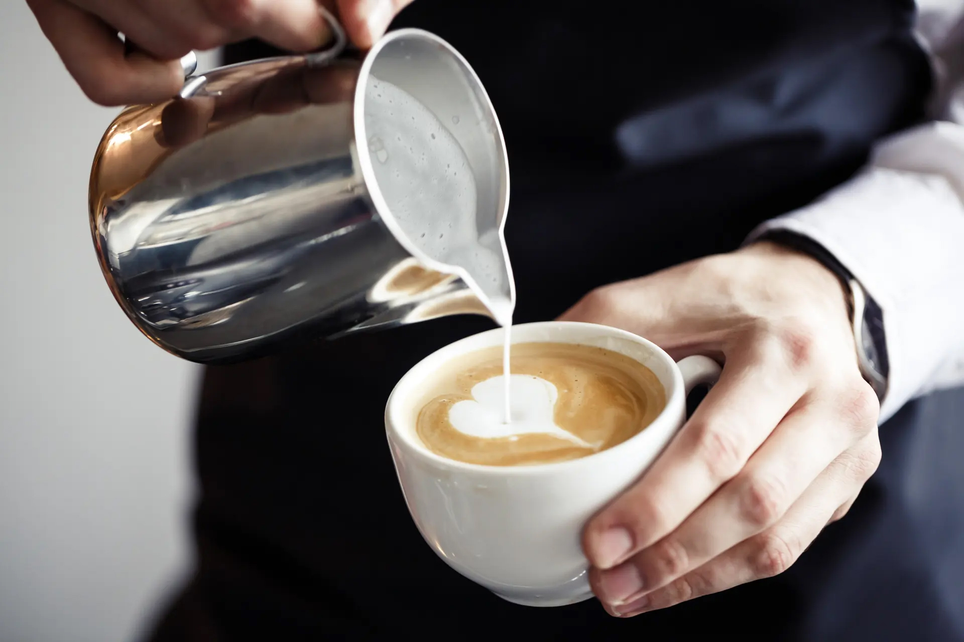 What are the benefits of adding milk to coffee?